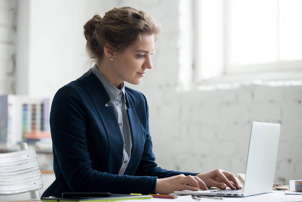 Professional working on a laptop in a bright office