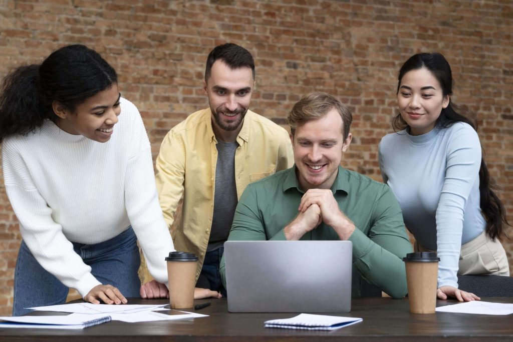 Small business team working together on laptops