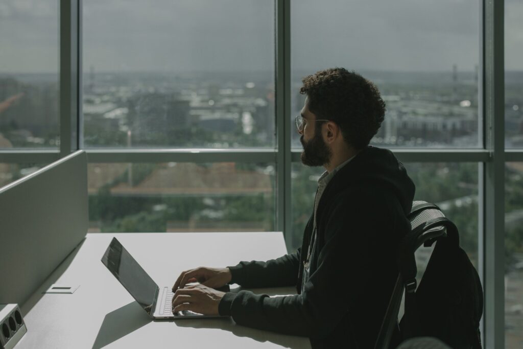 IT professional working at a desk by the window