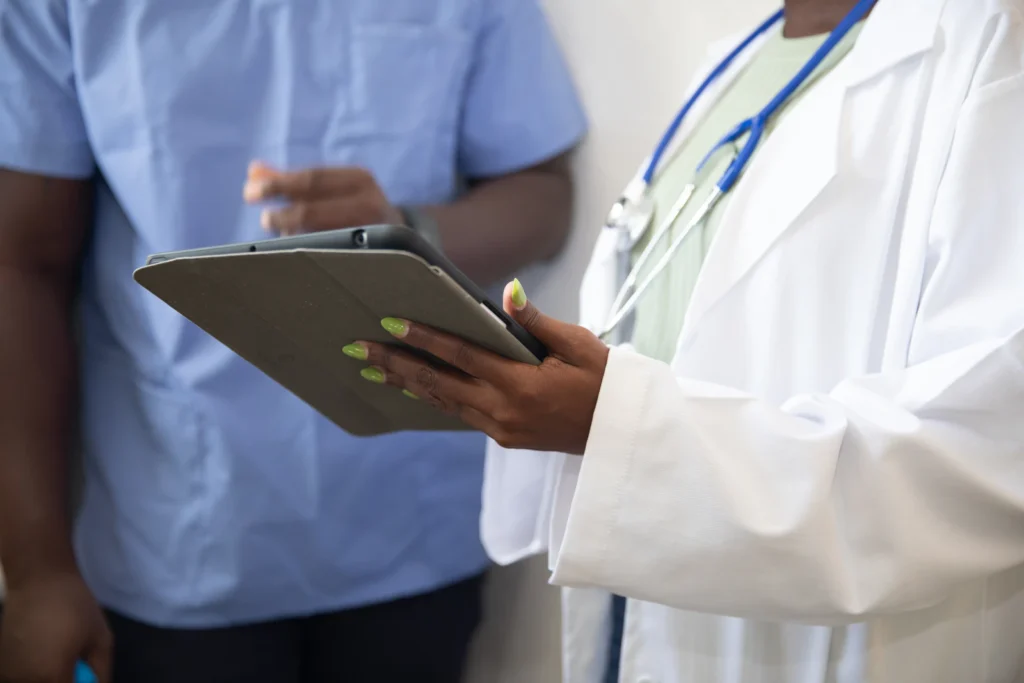 Doctor showing a patient information on a tablet in a clinic